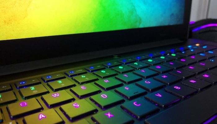 A gaming laptop with purple backlit keys