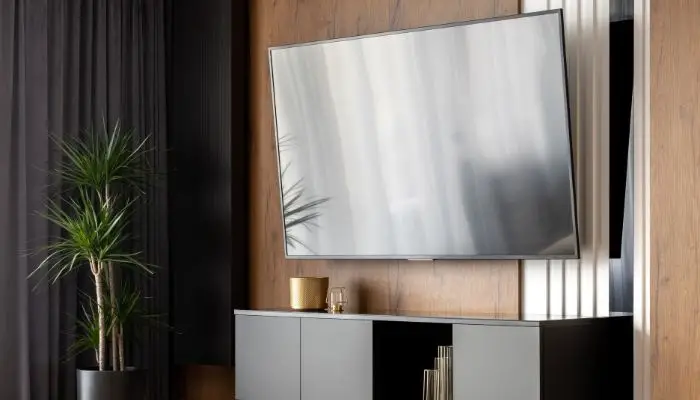 A OLED TV hanging on a wall
