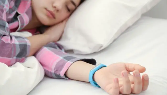 a woman tracking her sleep with a Fitbit