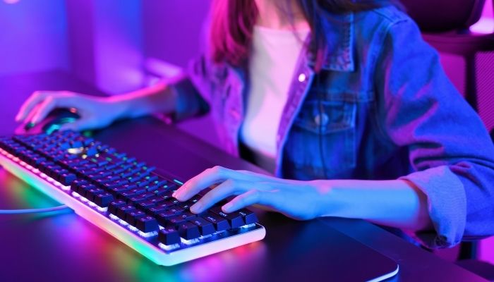 A girl playing PC games with a gaming mouse
