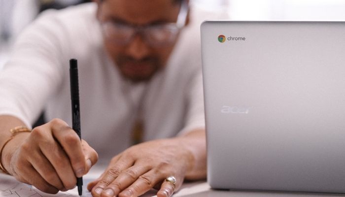 A man doing graphic design work on a Chromebook