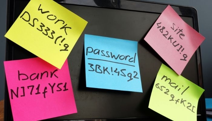 Passwords written down and stuck all over a laptop