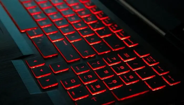 A gaming laptop with a red backlit keyboard