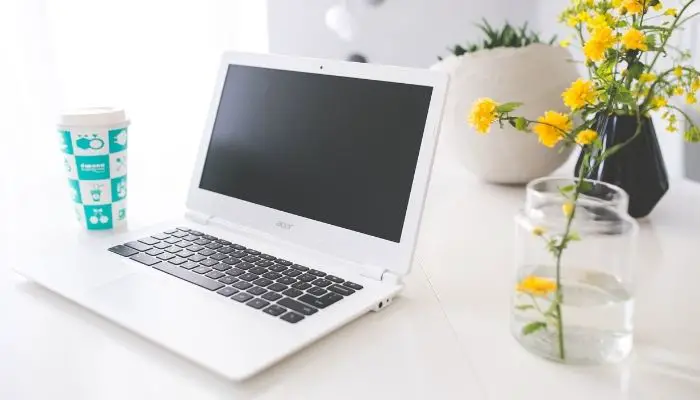 A white Chromebook with a black keyboard