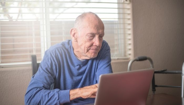 An elderly man using a Chromebook