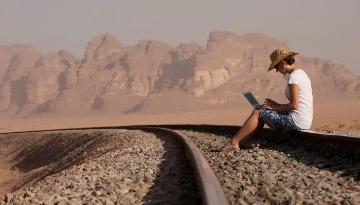 A man using his Chromebook while traveling