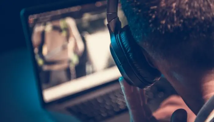 A man producing music on a gaming laptop